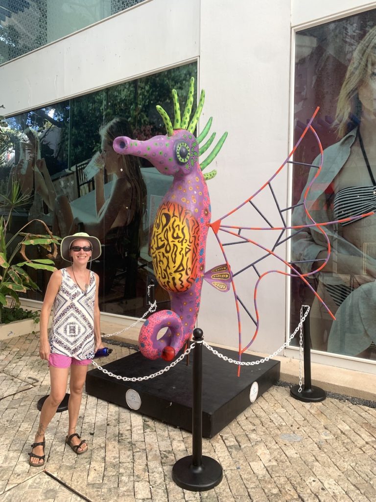 Mrs. ItchyFeet next to statue in Playa