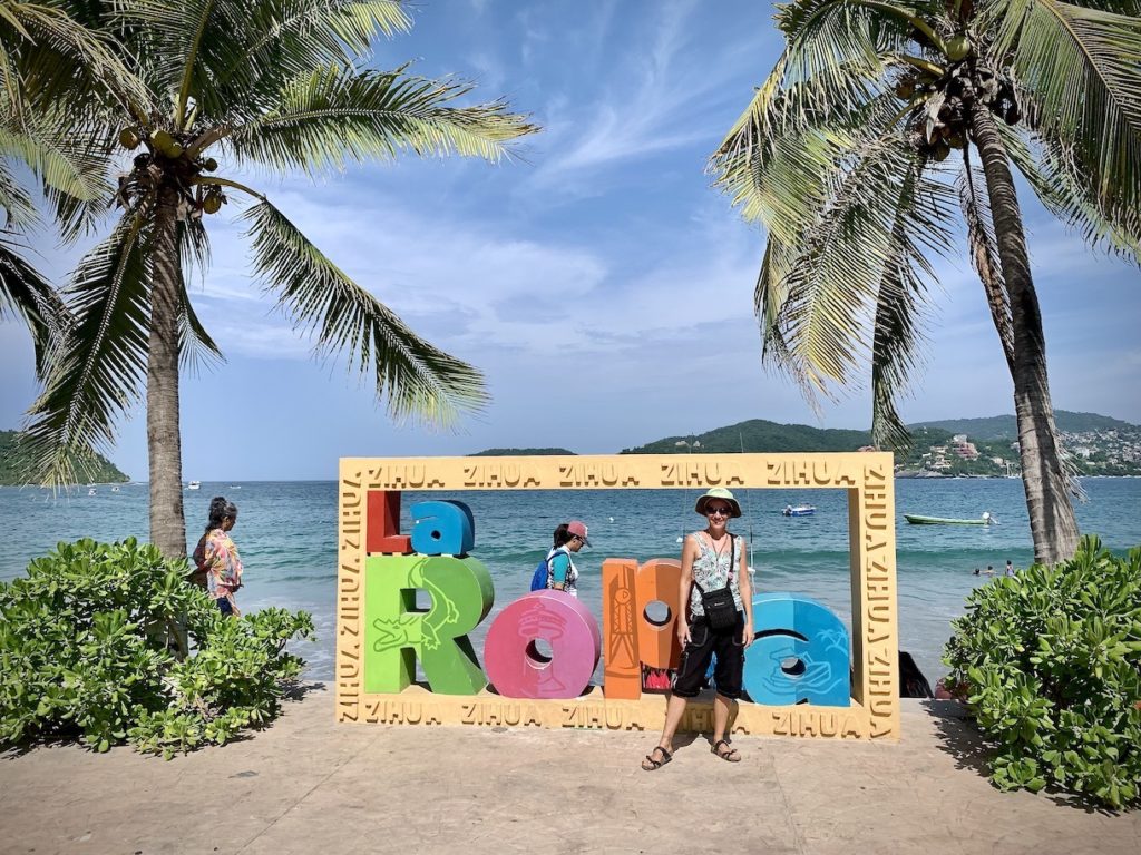 Mrs. ItchyFeet in front of Playa la Ropa sign