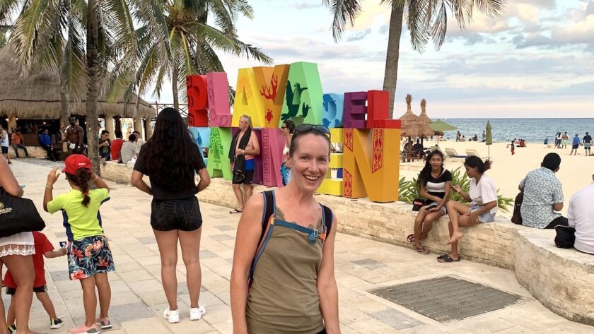Mrs. ItchyFeet in front of Playa del Carmen sign