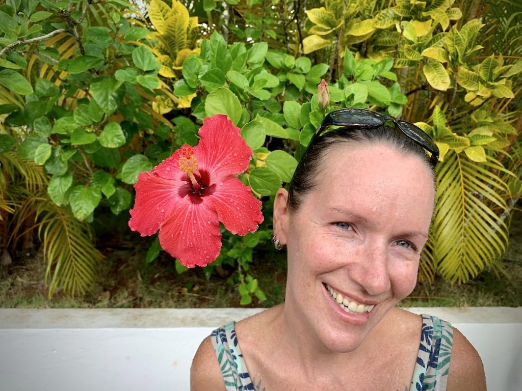 Mrs. ItchyFeet next to a giant hibiscus flower