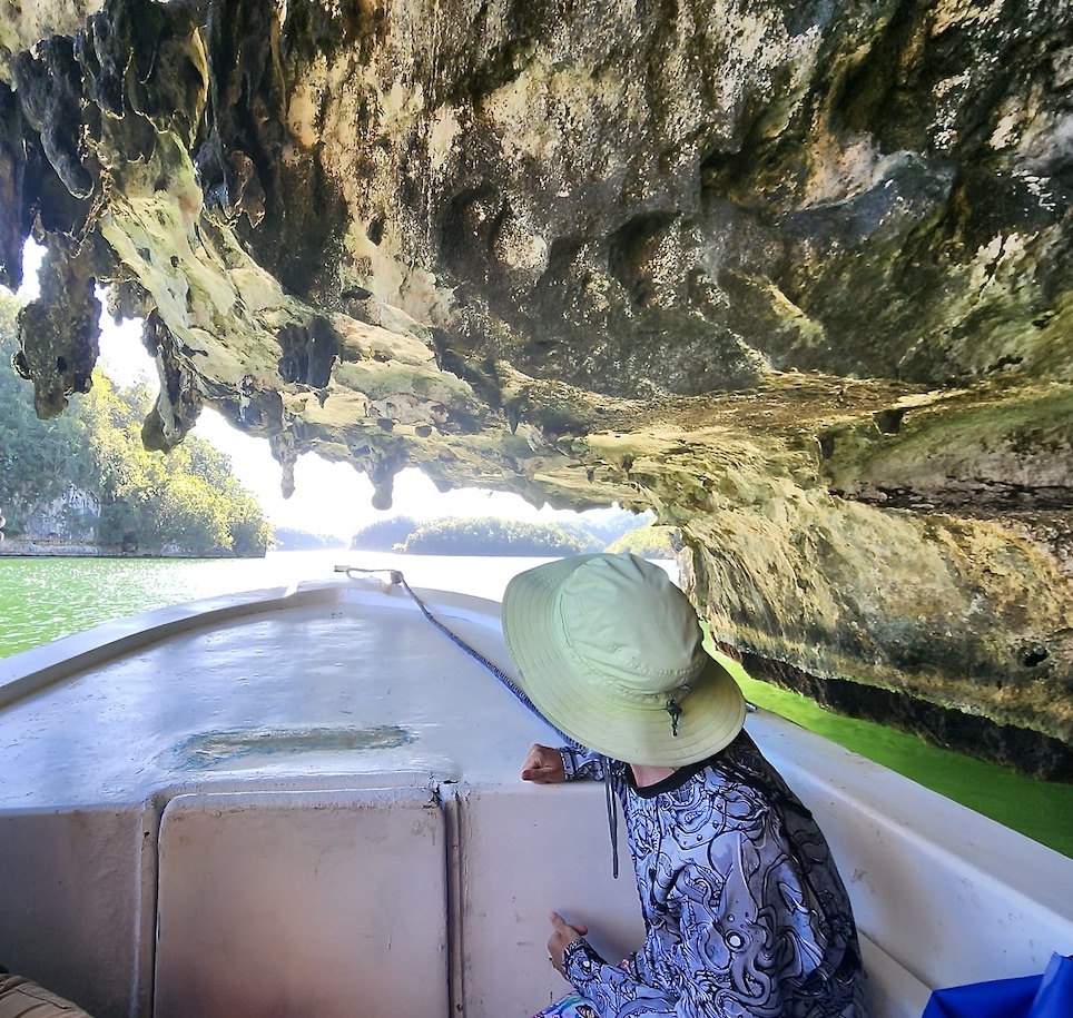 Mrs. ItchyFeet in a boat inside a cave