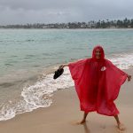 Mrs. ItchyFeet in the rain on the beach