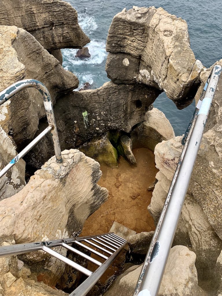 Ladder into cave on the side of a cliff