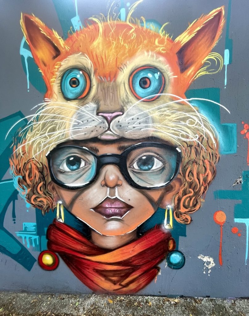 Street art of woman in cat hat