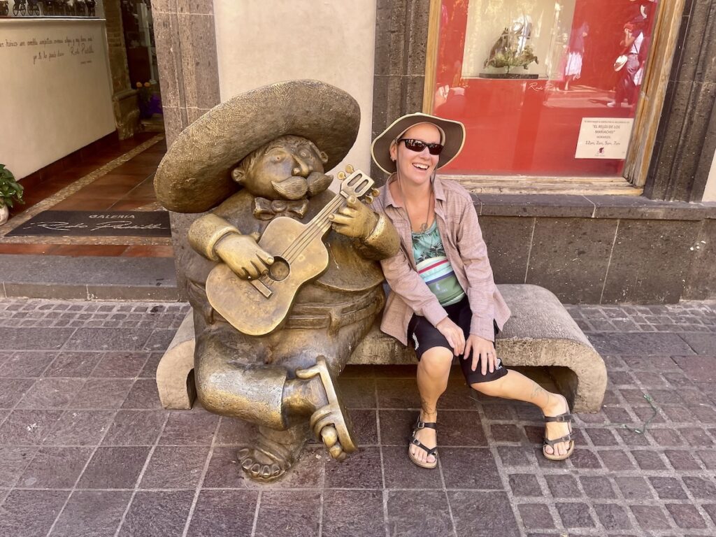Mrs. ItchyFeet with mariachi statue