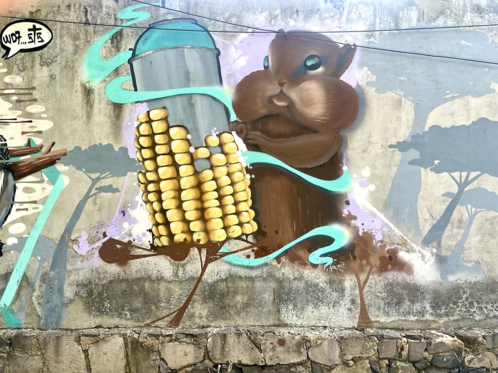 Street art of squirrel with corn-cob spray-paint can