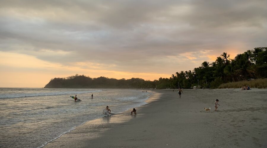 Sámara Beach sunset with surfer exiting ocean