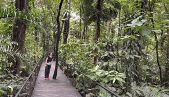 Mrs. ItchyFeet on botanical garden boardwalk