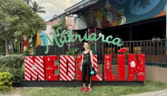 Mrs. ItchyFeet in front of Medellín letters