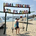Mrs. ItchyFeet on Playa Principal with fisherman’s storage and sailfish statue in distance