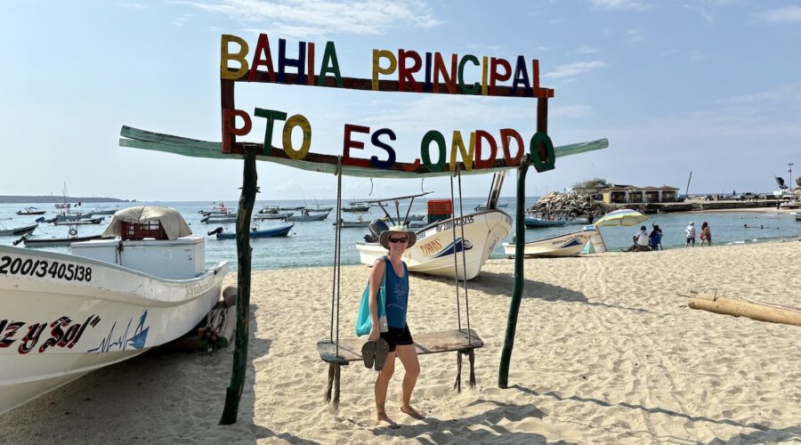 Mrs. ItchyFeet on Playa Principal with fisherman’s storage and sailfish statue in distance