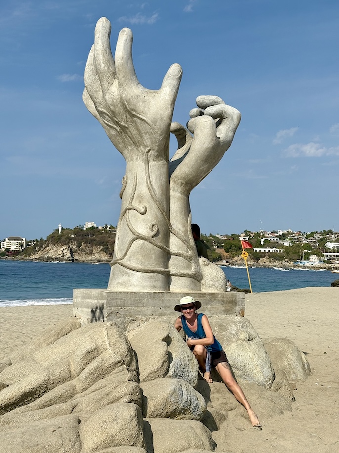 Mrs. ItchyFeet on hands sculpture