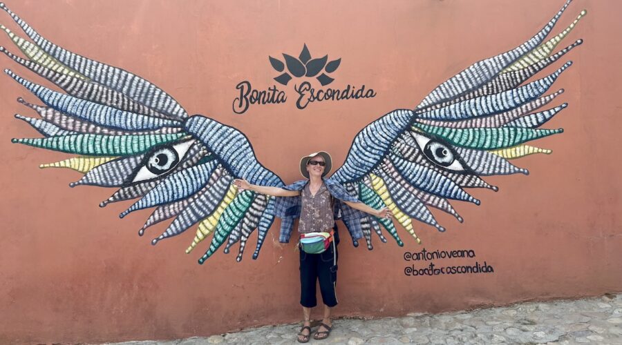 Mrs. ItchyFeet in front of wings mural