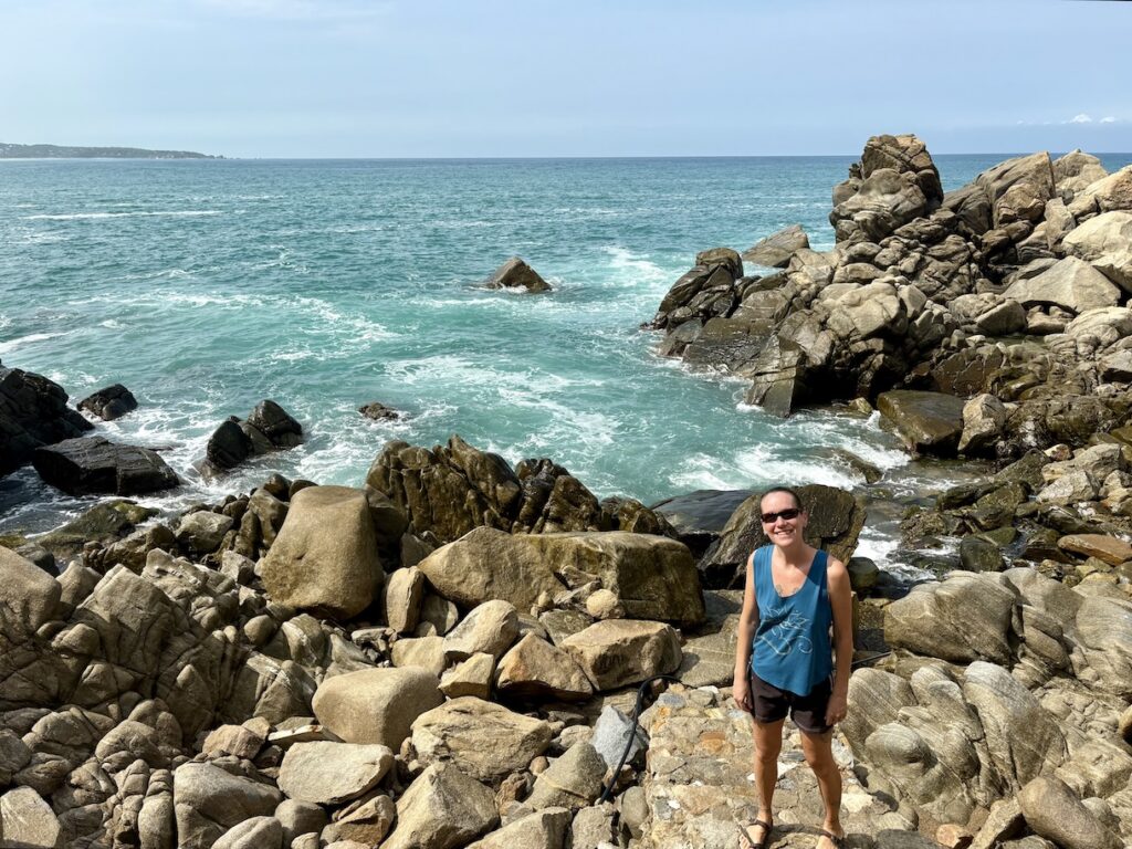 Mrs. ItchyFeet on rocks by ocean
