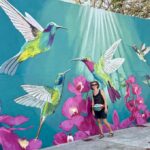 Mrs. ItchyFeet in front of hummingbird mural