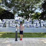 Mrs. ItchyFeet in front of Vietnam letters