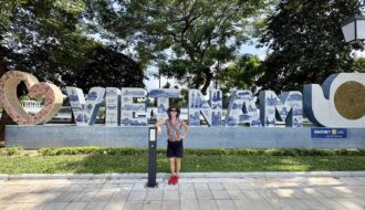 Mrs. ItchyFeet in front of Vietnam letters