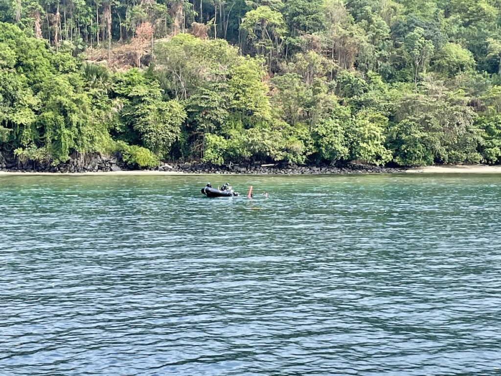 Dinghy driver picking up scuba divers