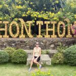 Mrs. ItchyFeet in front of Hon Thom letters