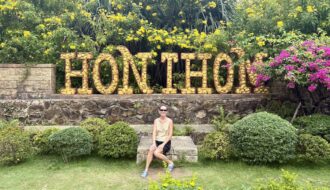 Mrs. ItchyFeet in front of Hon Thom letters