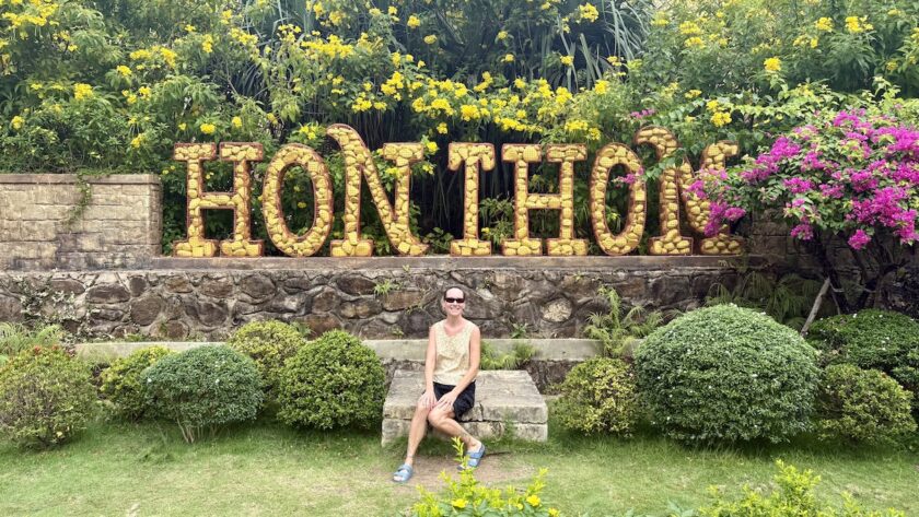 Mrs. ItchyFeet in front of Hon Thom letters