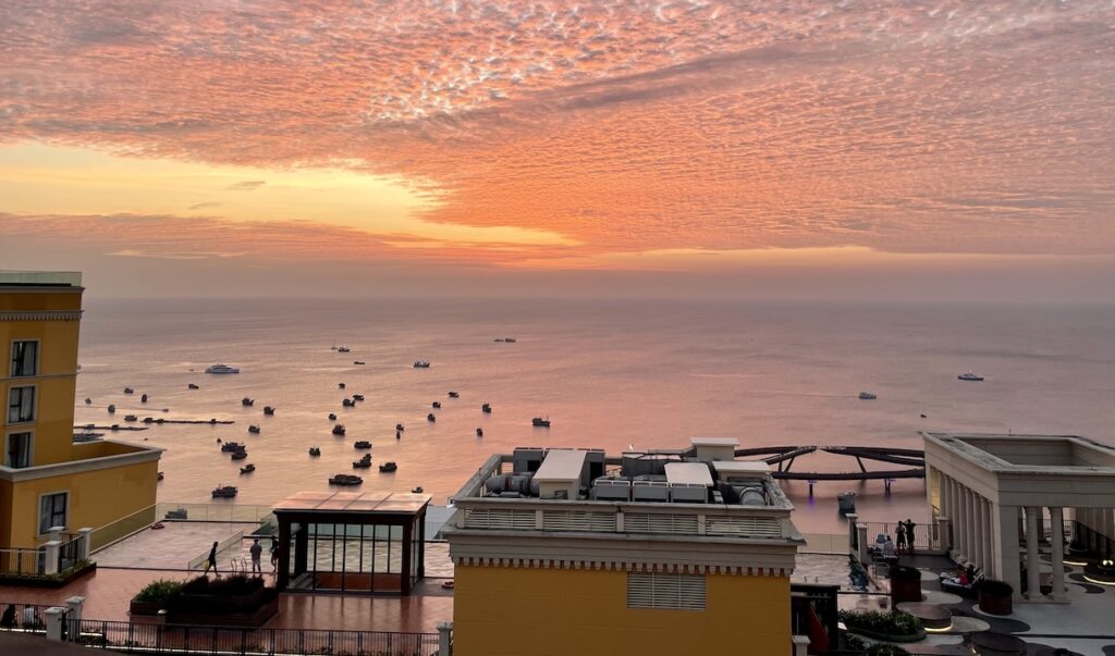 Neighbor's pool and sunset over Kiss Bridge from my balcony