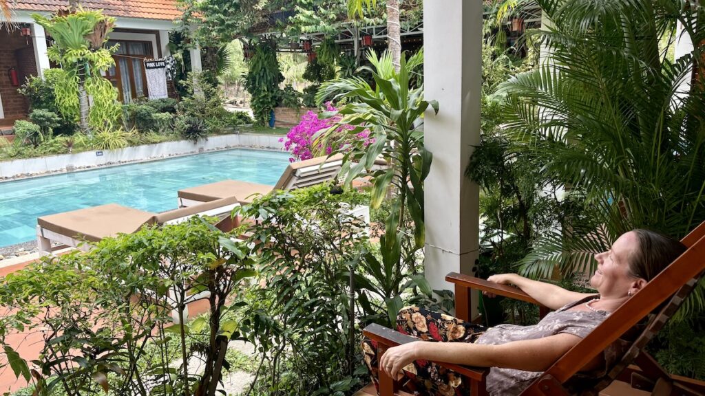 Mrs. ItchyFeet on porch in front of pool