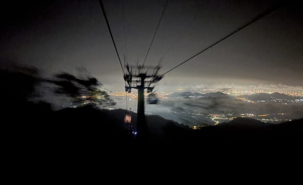 Aerial cable car ride at night with Da Nang in the distance