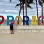 Mrs. ItchyFeet in front of Boracay letters