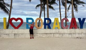 Mrs. ItchyFeet in front of Boracay letters